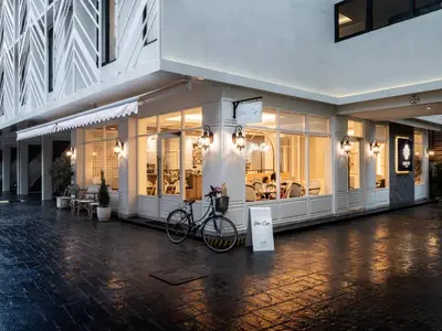 a bike parked in front of a building at Lucky Hotel Bangkok in Bangkok