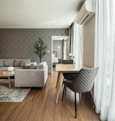 a living room with a couch and a table at Lucky Hotel Bangkok in Bangkok