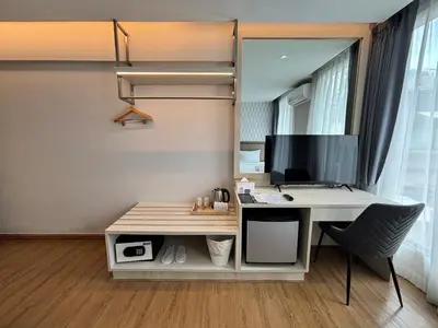 an office with a desk with a computer and a chair at Lucky Hotel Bangkok in Bangkok