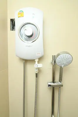 a washing machine and a shower in a bathroom at Poonsuk Place Hotel in Bangkok Noi