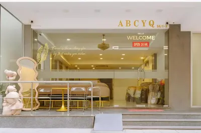 a store window with a table and chairs in it at ABCYQ Hotel in Bangkok