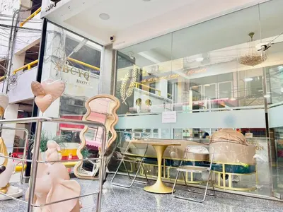 a store window with chairs and a table in it at ABCYQ Hotel in Bangkok