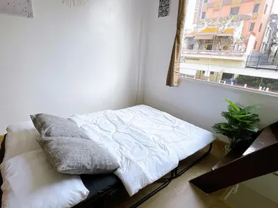 a bed sitting in a room with a window at Lively and cozy canal house ,Entire house in Bangkok