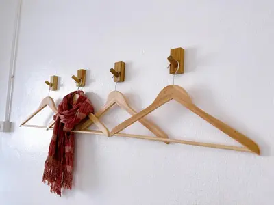a bunch of wooden hangers hanging on a wall at Lively and cozy canal house ,Entire house in Bangkok