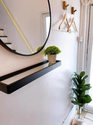 a hallway with a mirror and plants on a shelf at Lively and cozy canal house ,Entire house in Bangkok