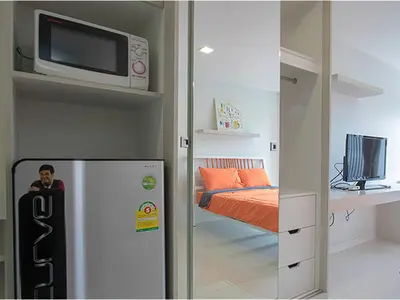 a small room with a refrigerator and a bed at Peaberry Place - พีเบอร์รี่เพลส in Ban Zong Katiam