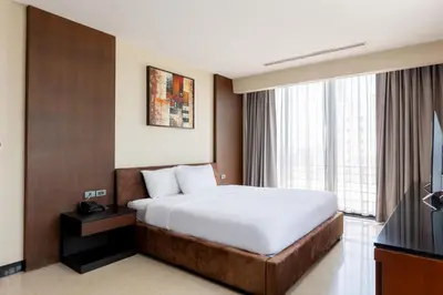 a hotel room with a bed and a television at Sukhothai Hotel and Residence Ratchada in Bangkok