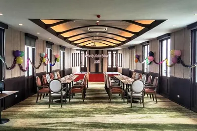 a banquet hall with tables and chairs and balloons at Bella B Hotel in Nonthaburi