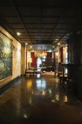 a living room with a table and a couch at Baan Tuk Din Hotel in Bangkok