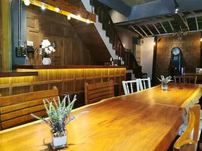 a dining room with a wooden table and chairs at Sri Ayuttaya Guesthouse in Bangkok