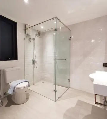a bathroom with a shower and a toilet and a sink at Sri Ayuttaya Guesthouse in Bangkok