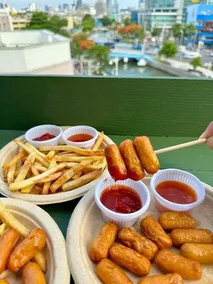 a table with plates of food with fries and ketchup at Sabai Dee Minitel in Dusit