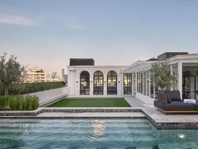 an exterior view of a house with a swimming pool at The Alberti Hotel - Sukhumvit 31 in Bangkok