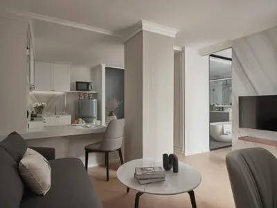 a living room with a couch and a table at The Alberti Hotel - Sukhumvit 31 in Bangkok