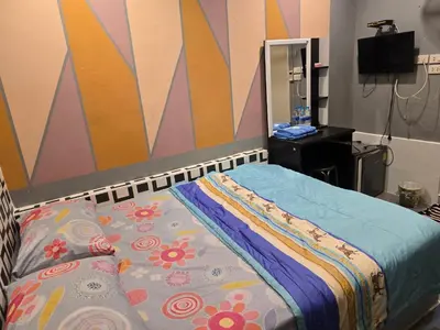 a bedroom with a bed and a mirror at BEN HOUSE in Bangkok