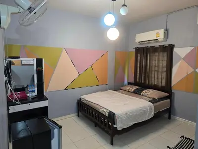 a bedroom with a bed and a colorful wall at BEN HOUSE in Bangkok
