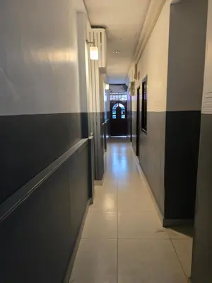 a hallway in a building with black and white walls at BEN HOUSE in Bangkok