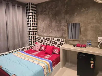 a bedroom with a bed with red pillows on it at BEN HOUSE in Bangkok
