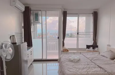 a bedroom with a bed and a large window at 32Sqm 1000x500wifi workplace long stay in Amphoe Phra Khanong