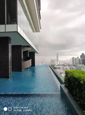 a swimming pool on the side of a building at Sathon Luxury High-rise Apartment City View KingPower ,IconSiam ,BNH,Silom in Bangkok