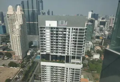 an aerial view of a tall building in a city at Sathon Luxury High-rise Apartment City View KingPower ,IconSiam ,BNH,Silom in Bangkok