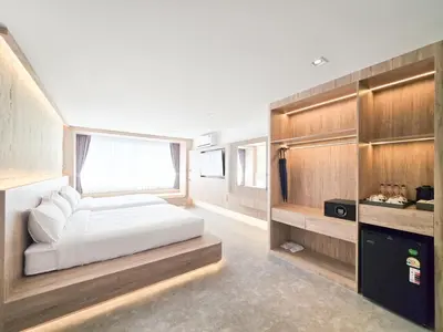 a bedroom with a bed and a tv in it at Ascella Bangkok Hotel in Makkasan