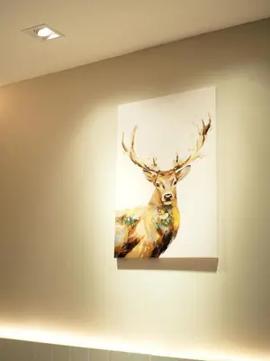 a painting of a deer hanging on a wall at Ascella Bangkok Hotel in Makkasan