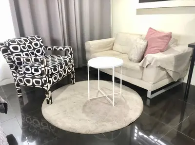 a living room with a couch and a table and chairs at CB's - Cheap Boutique Bangkok in Bangkok