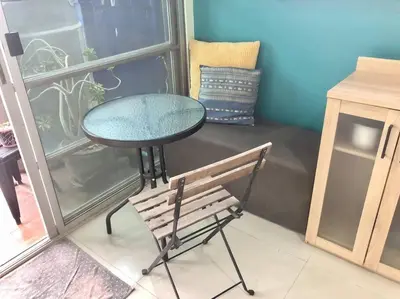 a table and a bench in front of a window at CB's - Cheap Boutique Bangkok in Bangkok
