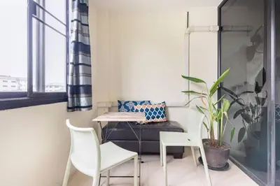 a small room with a table and chairs and a window at CB's - Cheap Boutique Bangkok in Bangkok
