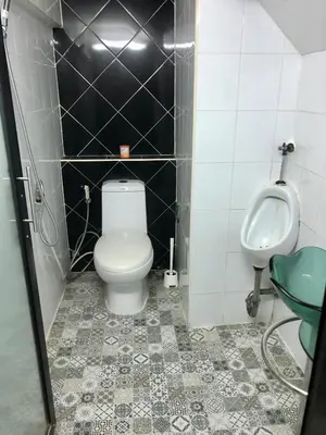 a bathroom with a toilet and a urinal and a sink at CB's - Cheap Boutique Bangkok in Bangkok