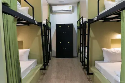 a hallway with four bunk beds in a room at All day hostel at BTS Bang Chak in Bangkok