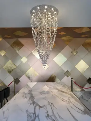 a chandelier in a room with a white table at S3 Siam Bangkok Hotel in Bangkok
