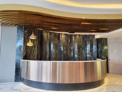 a lobby with a reception desk in a building at S3 Siam Bangkok Hotel in Bangkok