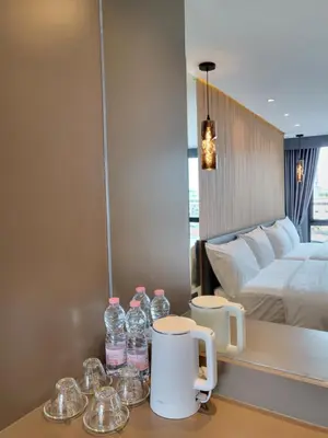 a hotel room with bottles of water on a table at S3 Siam Bangkok Hotel in Bangkok