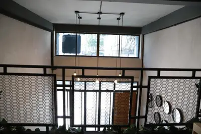 a room with a large window and a chandelier at The Cube Hostel Khaosan in Bangkok