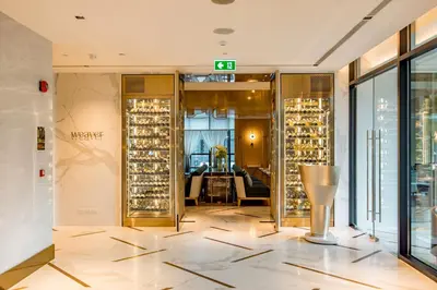 a room with a door to a room with wine bottles at SILQ Hotel & Residence in Bangkok