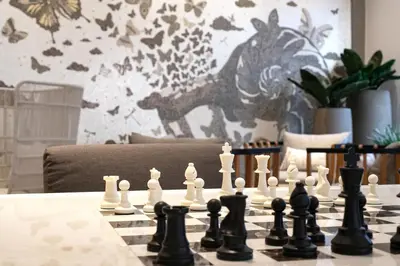 a chess game on a table with a chessboard at SILQ Hotel & Residence in Bangkok
