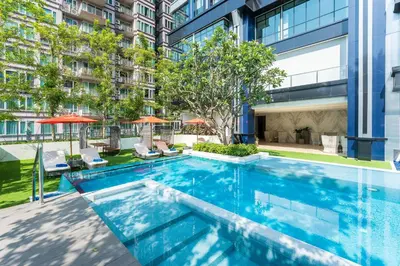 an infinity pool in the courtyard of a building at SILQ Hotel & Residence in Bangkok