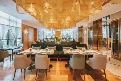 a large dining room with a large chandelier at SILQ Hotel & Residence in Bangkok