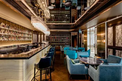 a bar at a restaurant with blue chairs and tables at SILQ Hotel & Residence in Bangkok
