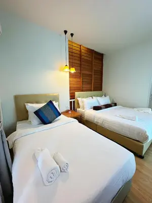 a hotel room with two beds with white sheets at CozyHouse near MRT QSCC Convention Center 4BR 10ppl in Bangkok