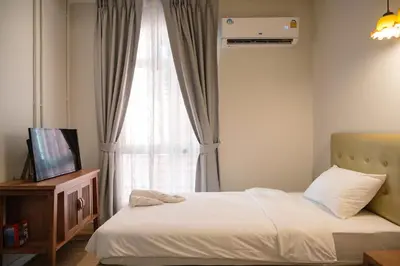 a bedroom with a bed and a window at CozyHouse near MRT QSCC Convention Center 4BR 10ppl in Bangkok