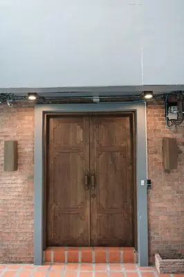 a wooden garage door with a brick wall at CozyHouse near MRT QSCC Convention Center 4BR 10ppl in Bangkok