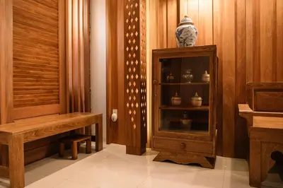 a room with a wooden cabinet with a vase on top at CozyHouse near MRT QSCC Convention Center 4BR 10ppl in Bangkok