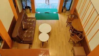 an overhead view of a living room with a couch and chairs at Asia Inn Bangkok 2022 in Bangkok
