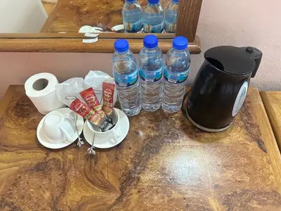 a table with two bottles of water and paper plates at Asia Inn Bangkok 2022 in Bangkok