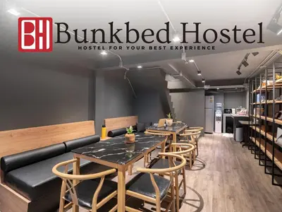 a row of tables and chairs in a restaurant at Bunkbed Hostel in Makkasan