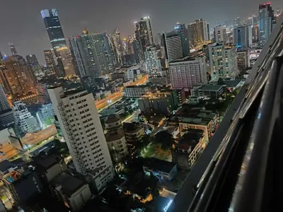 a city skyline at night with tall buildings at Omni Tower Nana Bangkok - Serviced Apartment on Sukhumvit Soi 4 in Bangkok