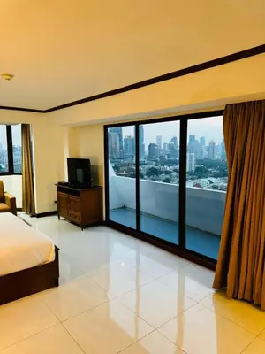 a hotel room with a view of a city at Omni Tower Nana Bangkok - Serviced Apartment on Sukhumvit Soi 4 in Bangkok